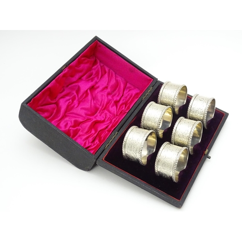 624 - A cased set of six Victorian silver napkin rings with engraved decoration and numbered 1-6, hallmark... 