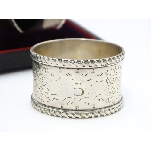 624 - A cased set of six Victorian silver napkin rings with engraved decoration and numbered 1-6, hallmark... 