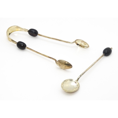 643 - A cased set of six silver coffee bean spoons with sugar tongs en suite, each with coffee bean finial... 