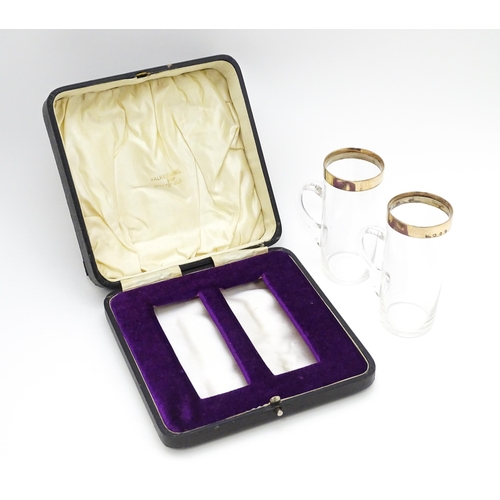 652 - A cased pair of Victorian glasses of mug form  with silver gilt mounts hallmarked Birmingham 1892, m... 