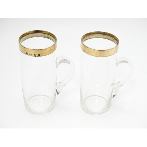 652 - A cased pair of Victorian glasses of mug form  with silver gilt mounts hallmarked Birmingham 1892, m... 