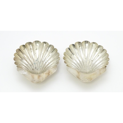 653 - A cased pair of silver butter dishes of scallop shell form, hallmarked Birmingham 1903 maker Minshul... 