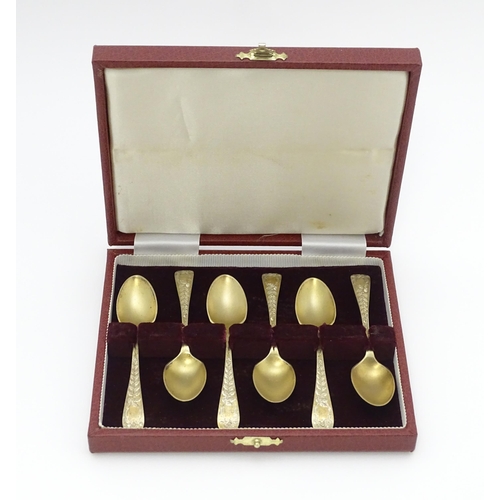 654 - A cased set of six silver gilt teaspoons with bright cut decoration hallmarked Sheffield 1902, maker... 