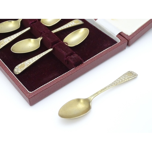 654 - A cased set of six silver gilt teaspoons with bright cut decoration hallmarked Sheffield 1902, maker... 