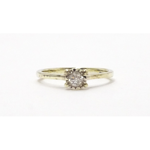 702 - A 9ct white gold ring set with diamond solitaire. Ring size approx. J 1/2