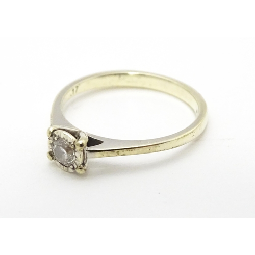 702 - A 9ct white gold ring set with diamond solitaire. Ring size approx. J 1/2