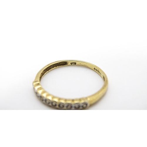 703 - A 9ct gold ring set with diamonds in a linear setting. Ring size approx. Q 1/2