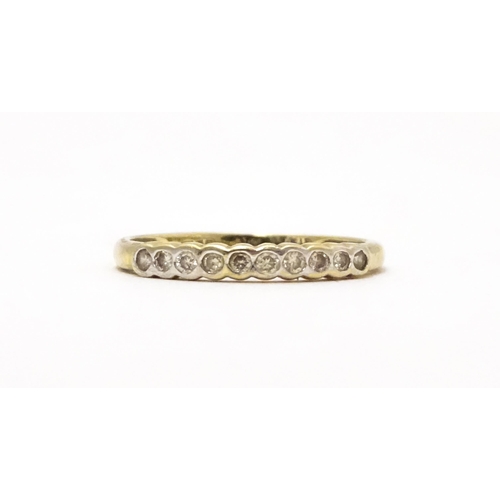 703 - A 9ct gold ring set with diamonds in a linear setting. Ring size approx. Q 1/2