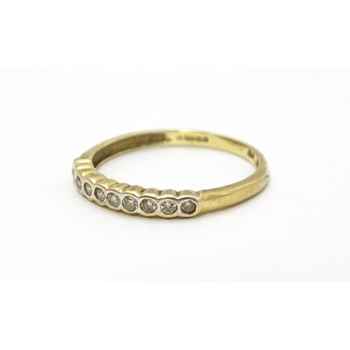 703 - A 9ct gold ring set with diamonds in a linear setting. Ring size approx. Q 1/2