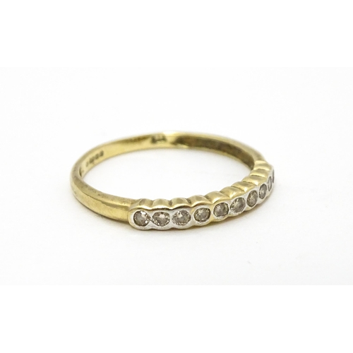 703 - A 9ct gold ring set with diamonds in a linear setting. Ring size approx. Q 1/2