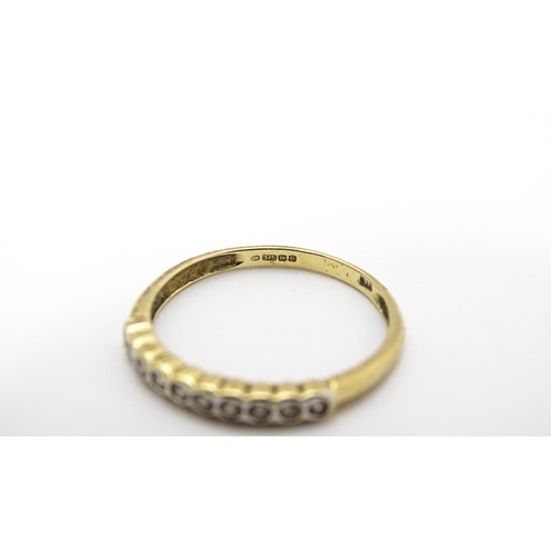 703 - A 9ct gold ring set with diamonds in a linear setting. Ring size approx. Q 1/2