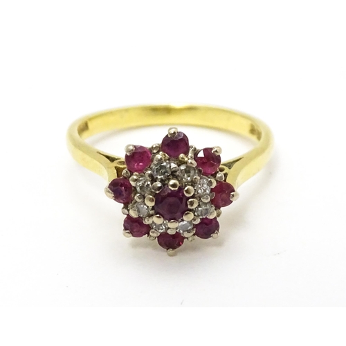 704 - An 18ct gold ring set with diamonds and red stones. Ring size approx. M 1/2