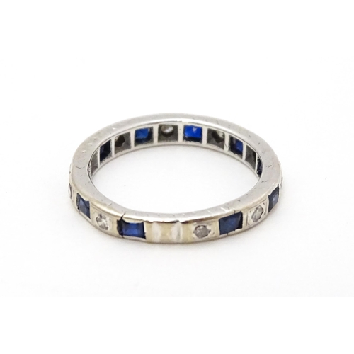 706 - A white gold eternity ring set with sapphires and diamonds. Ring size approx. L 1/2