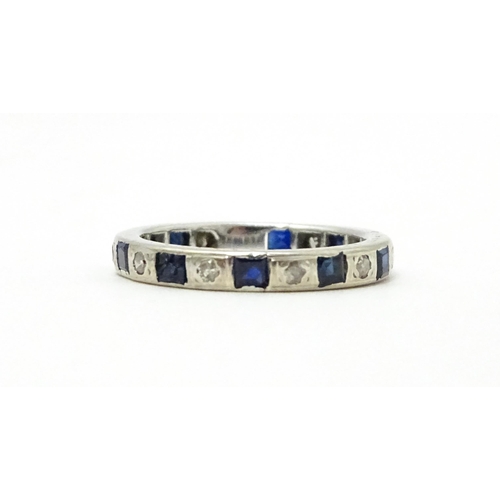 706 - A white gold eternity ring set with sapphires and diamonds. Ring size approx. L 1/2