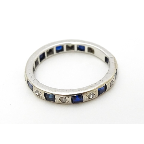 706 - A white gold eternity ring set with sapphires and diamonds. Ring size approx. L 1/2