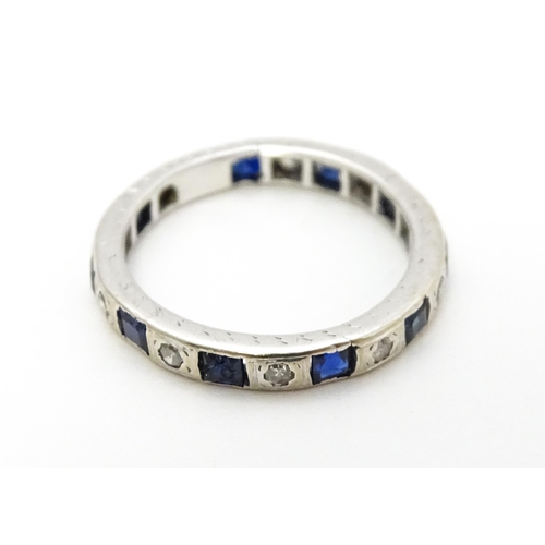 706 - A white gold eternity ring set with sapphires and diamonds. Ring size approx. L 1/2