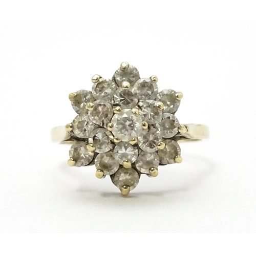 707 - A 9ct gold ring set with diamonds in a floral cluster setting. Ring size approx. M