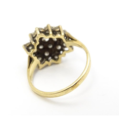 707 - A 9ct gold ring set with diamonds in a floral cluster setting. Ring size approx. M