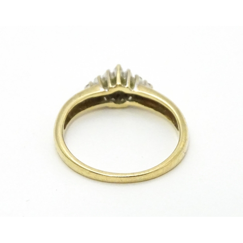 708 - A 9ct gold ring set with diamond cluster. Ring size approx. K 1/2