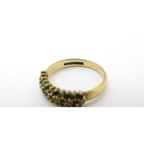 709 - A 9ct gold ring set with emeralds and diamonds. Ring size approx. K