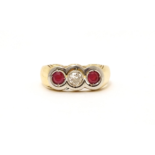 711 - A yellow gold ring set with central diamond  flanked by rubies. Ring size approx. P