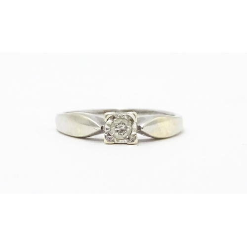 712 - A 9ct white gold ring set with a diamond solitaire. Ring size approx. K