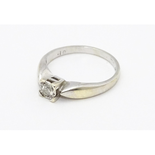 712 - A 9ct white gold ring set with a diamond solitaire. Ring size approx. K