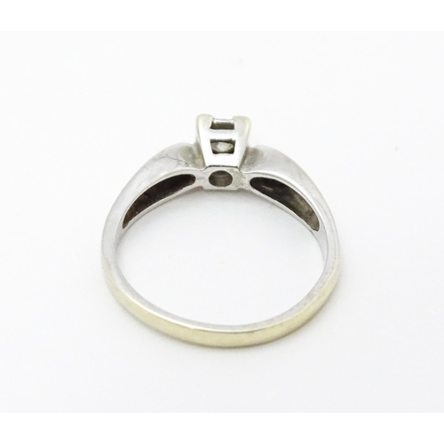 712 - A 9ct white gold ring set with a diamond solitaire. Ring size approx. K