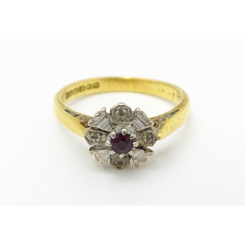 713 - An 18ct gold ring set with central ruby. Ring size approx. J