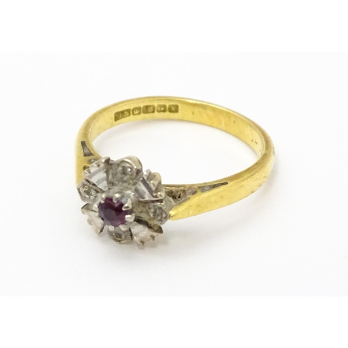 713 - An 18ct gold ring set with central ruby. Ring size approx. J