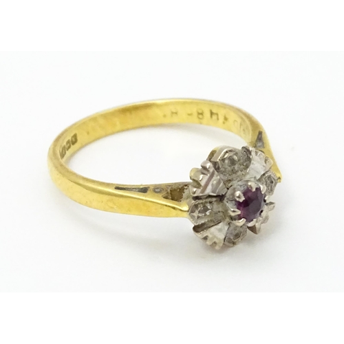 713 - An 18ct gold ring set with central ruby. Ring size approx. J