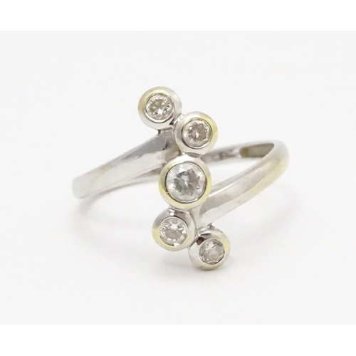 716 - A 14ct white gold ring set with five white stones. Ring size approx. U