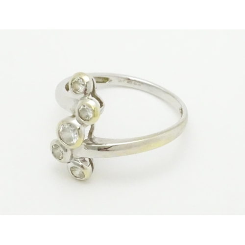 716 - A 14ct white gold ring set with five white stones. Ring size approx. U