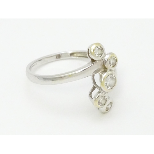 716 - A 14ct white gold ring set with five white stones. Ring size approx. U