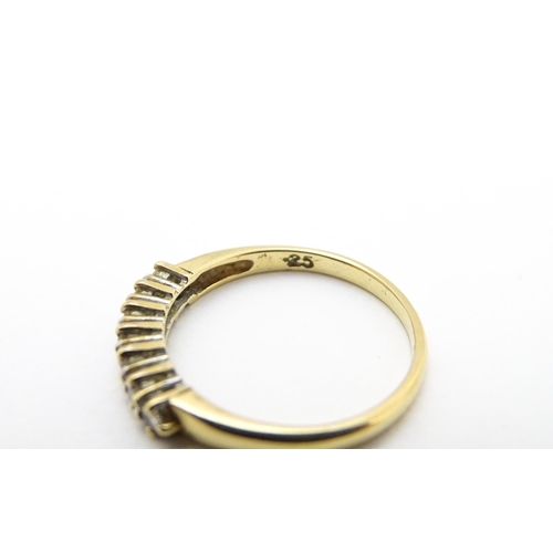 720 - A 9ct gold ring set with seven diamonds in a linear setting. Ring size approx. K 1/2