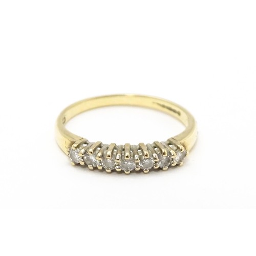 720 - A 9ct gold ring set with seven diamonds in a linear setting. Ring size approx. K 1/2