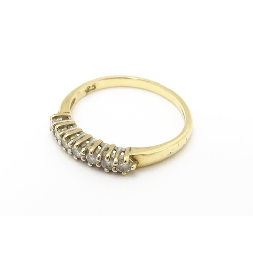 720 - A 9ct gold ring set with seven diamonds in a linear setting. Ring size approx. K 1/2