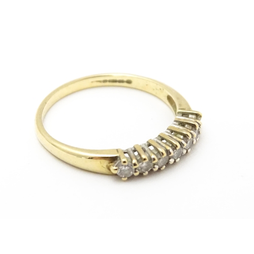 720 - A 9ct gold ring set with seven diamonds in a linear setting. Ring size approx. K 1/2