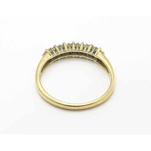 720 - A 9ct gold ring set with seven diamonds in a linear setting. Ring size approx. K 1/2