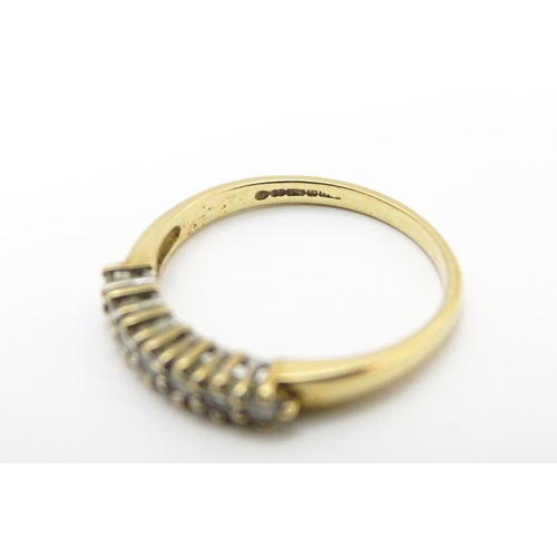 720 - A 9ct gold ring set with seven diamonds in a linear setting. Ring size approx. K 1/2