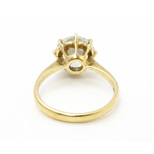 721 - A 9ct gold ring set with a white stone solitaire. Ring size approx. O