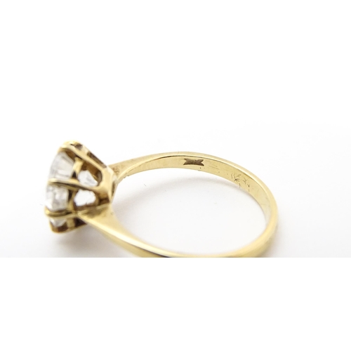 721 - A 9ct gold ring set with a white stone solitaire. Ring size approx. O