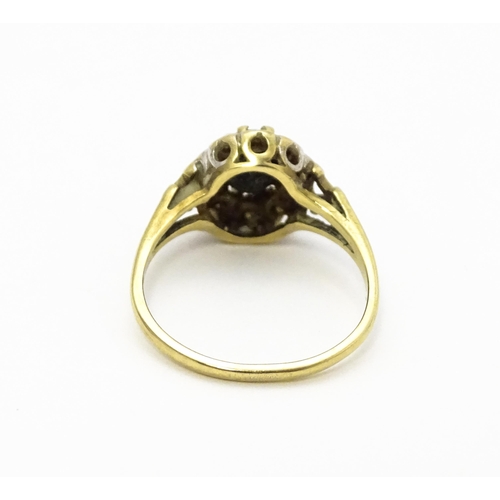 723 - A 9ct gold ring set with central sapphire bordered by diamonds. Ring size approx.  L 1/2