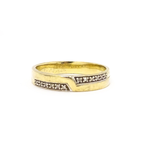 725 - A 9ct gold ring set with white stones in white metal settings. Ring size approx. T