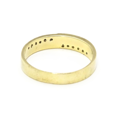 725 - A 9ct gold ring set with white stones in white metal settings. Ring size approx. T