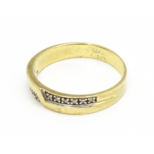 725 - A 9ct gold ring set with white stones in white metal settings. Ring size approx. T