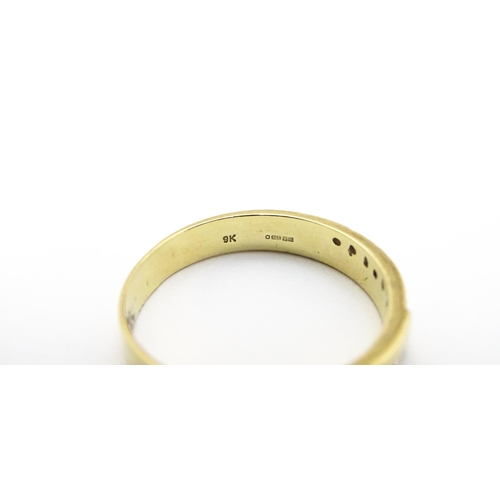 725 - A 9ct gold ring set with white stones in white metal settings. Ring size approx. T