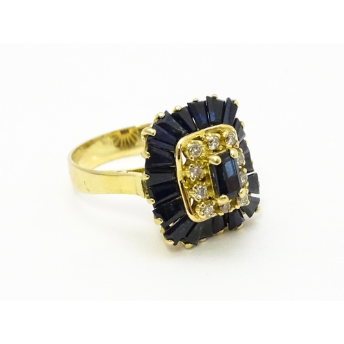 726 - A yellow metal cocktail ring set with central sapphire blue coloured stone bordered by diamonds and ... 