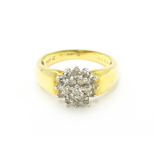 729 - An 18ct gold ring  set with diamond cluster. Ring size approx. L.