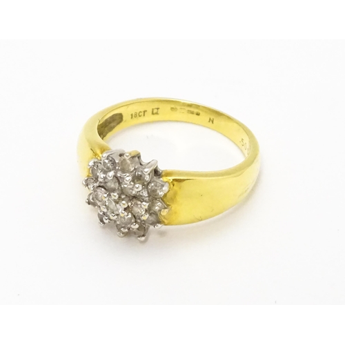 729 - An 18ct gold ring  set with diamond cluster. Ring size approx. L.